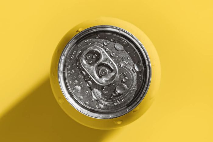 A yellow can viewed from above on a yellow background