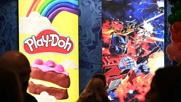 Signs featuring Play-Doh and Transformers are displayed.