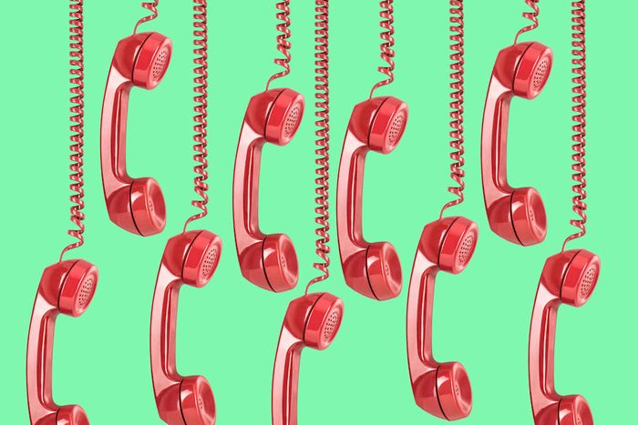 red telephone receivers displayed on a green background