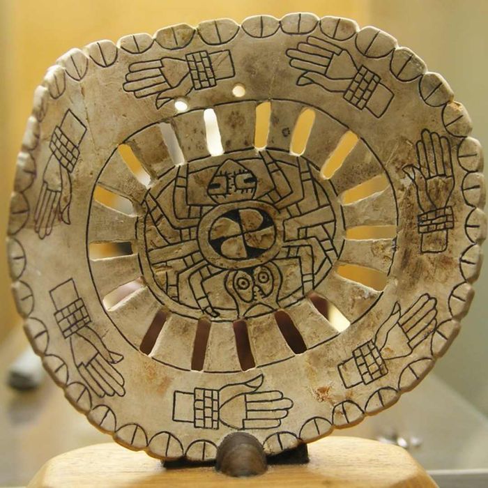 A Mississippian spider shell gorget (ornamental collar) discovered at the Spiro Mounds archaeological site in Oklahoma.