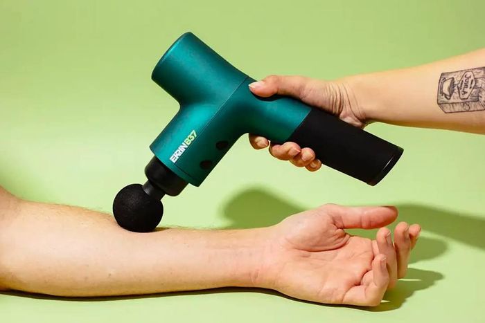 Leading massage guns: The Ekrin Athletics B37 Massage Gun in use on a forearm.