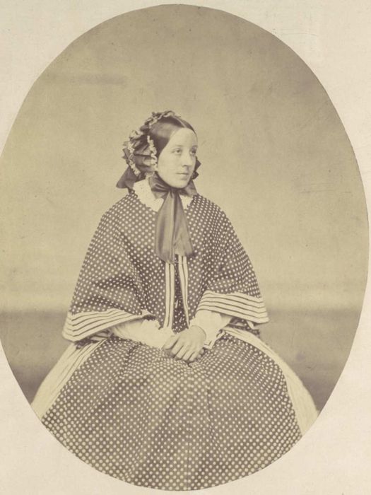 A portrait of a Victorian-era woman wearing a dress adorned with polka dots.