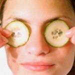A woman relaxing with cucumber slices over her eyes