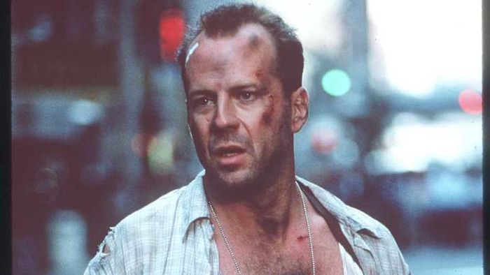 Bruce Willis portraying NYPD officer John McClane in the iconic 'Die Hard' series.