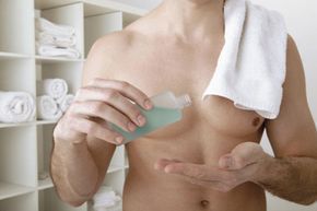 man applying moisturizer
