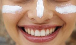 woman with white zinc oxide sunscreen on her face