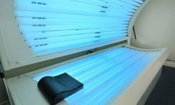 A tanning bed with its lights on, showcasing all of its lamps. Nikon D700 Full Size Sensor Image.