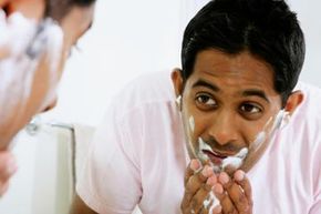 A woman applies a cleansing pad to her face