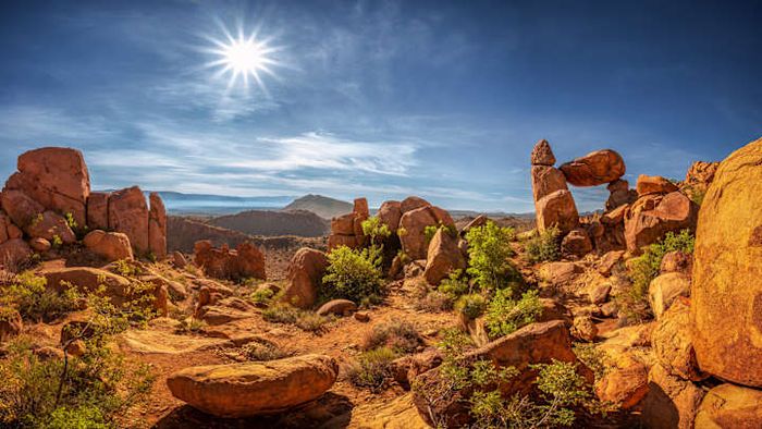 Balanced Rock (right), a distinctive geological feature, basks in the sunlight at Big Bend National Park.