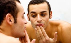 a man examining his dry skin