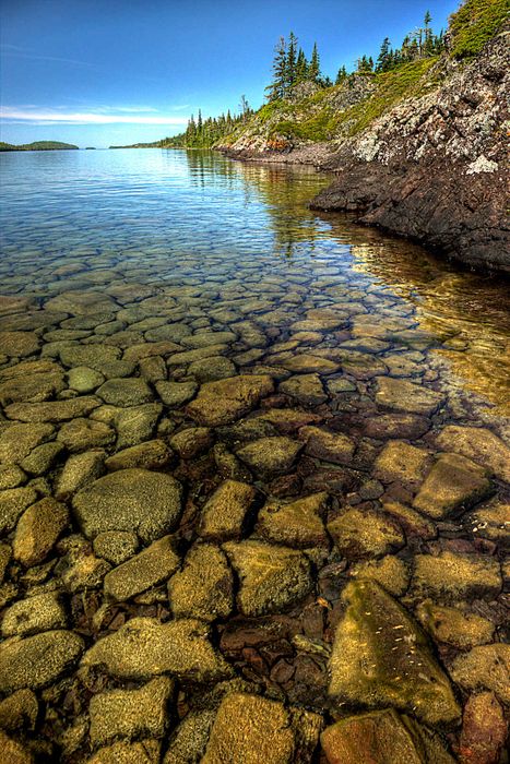 In Isle Royale National Park, smooth cobblestones beneath pristine, clear waters interlock like pieces of a natural jigsaw puzzle.