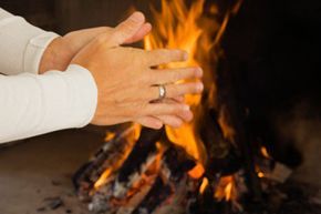 Heating hands near a fire