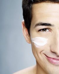 a man applying lotion to his face