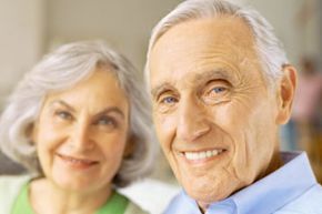 A smiling portrait of an elderly couple.