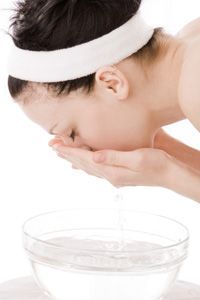 A woman cleansing her face