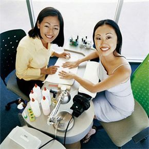 A woman receiving a manicure