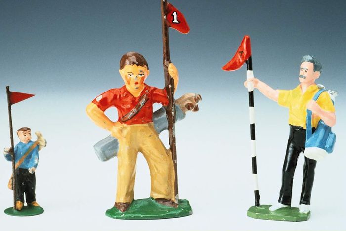 Three vintage lead golf caddy figurines from the 1930s.