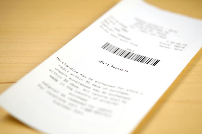 A gift receipt placed on a table with selective focus on the words 
