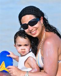 mother and baby applying sunscreen