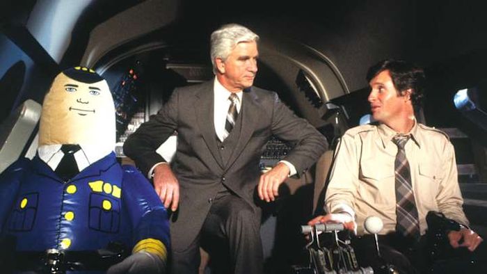 The iconic trio Otto, Leslie Nielsen, and Robert Hays star in the classic comedy 'Airplane!' (1980).