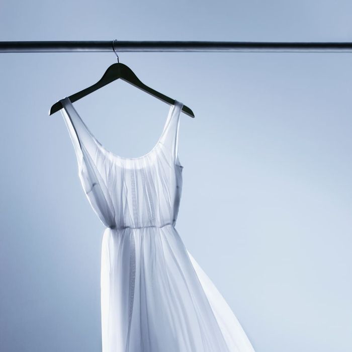 A white dress, not associated with Emily Dickinson, is shown.