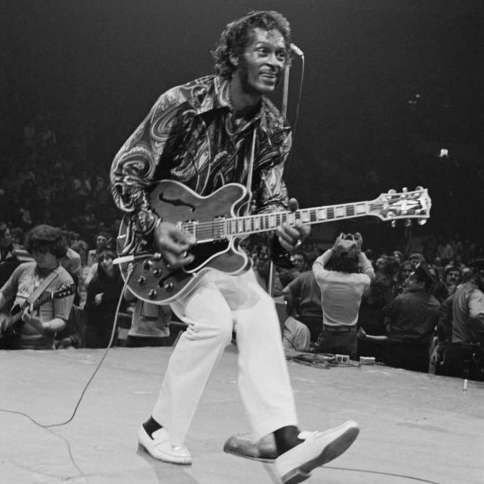 Chuck Berry performing live on stage with his guitar.