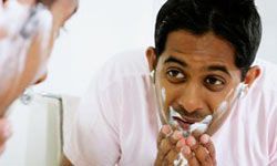 man cleansing his face