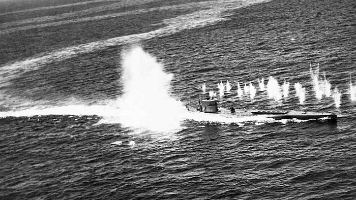 A depth charge detonating near a submarine.