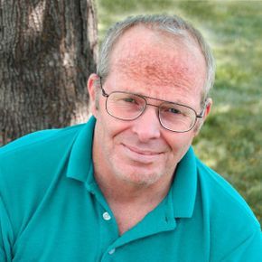 A man exhibits a skin condition on his forehead.