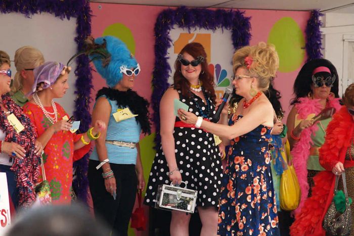 Women adorned with beehive hairstyles, vintage dresses, and retro accessories