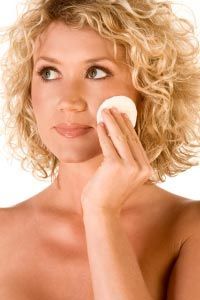 A woman applying a no-rinse facial cloth.