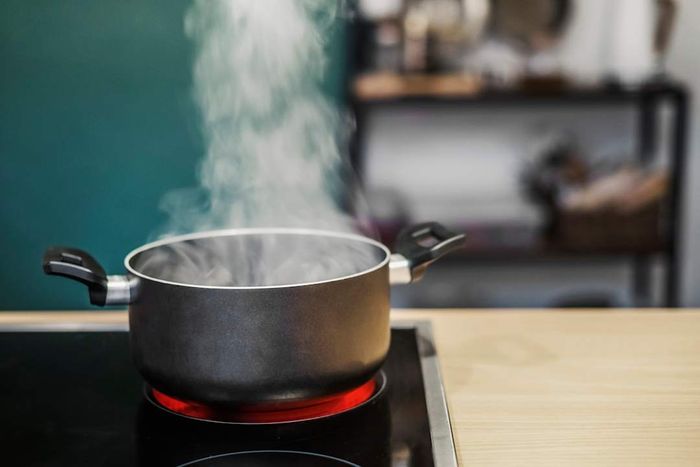 A pot of hot water heating on the stove