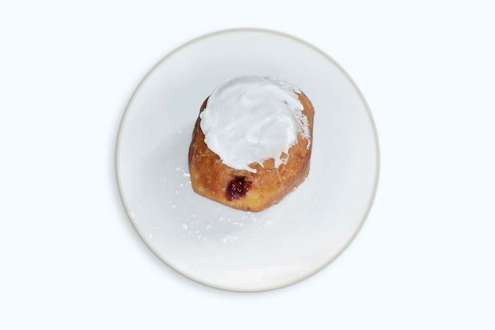 A paczki on a white plate.