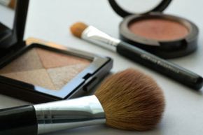A variety of cosmetics and their application tools.