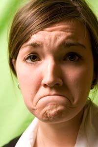 A woman with a deep frown.
