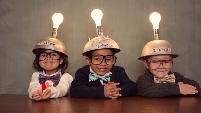 Three clever children wearing their thinking caps.