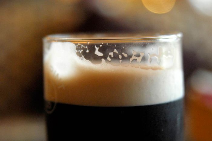 The creamy foam on a glass of Guinness.