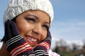 A woman bundled up in a cozy winter hat and gloves.