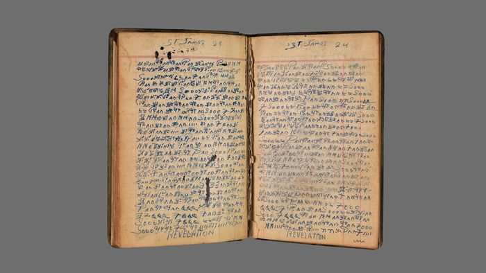 An open notebook filled with coded handwriting