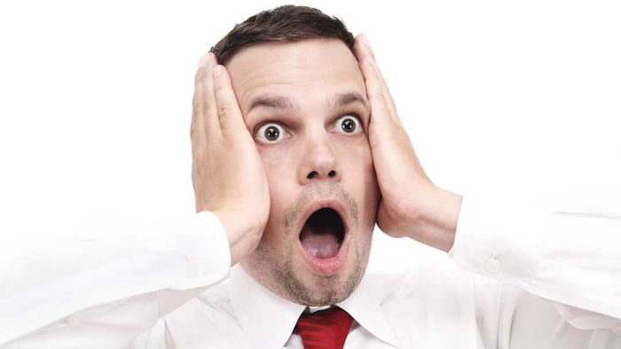 A man is shown looking nervous