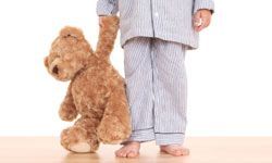 A little boy holding a teddy bear