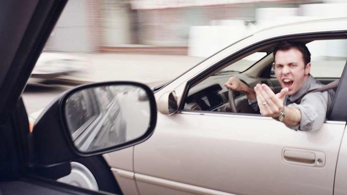 A man is shown driving a car