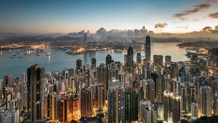 The Hong Kong skyline illuminated by the morning sun.