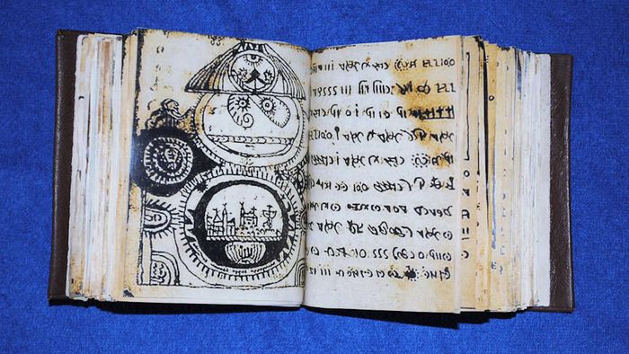 A book featuring an odd script and illustrations.