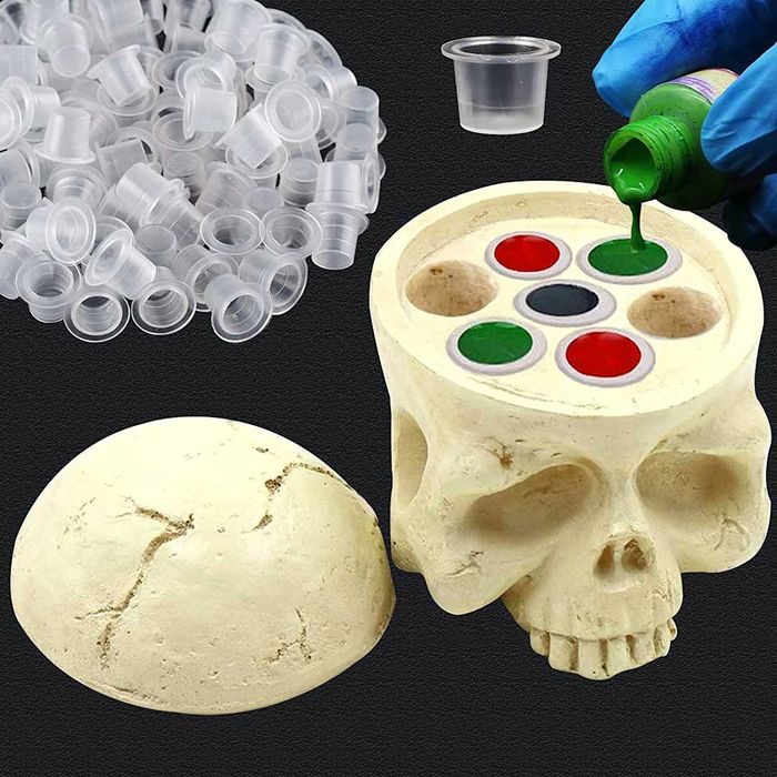 A fake skull designed to hold ink cups.