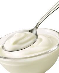 A bowl of yogurt with a spoon
