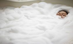 a boy relaxing in a bathtub