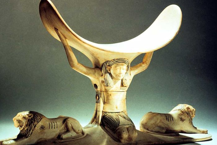 An ivory headrest supported by a carved figure, dating back to Ancient Egypt's 18th Dynasty, circa 1325 BC.