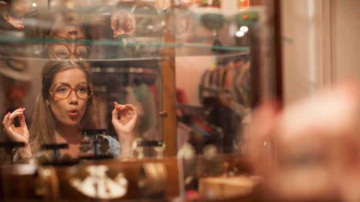 A woman is shown wearing eyeglasses