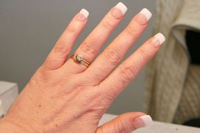 A woman showing off her acrylic nails.